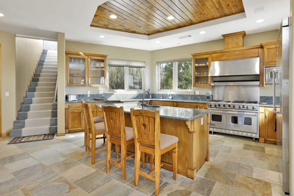 Fully equipped cabin kitchen with ample cabinetry, stove, fridge, microwave, and coffee maker—perfect for cooking meals, morning coffee, and feeling right at home on your stay.