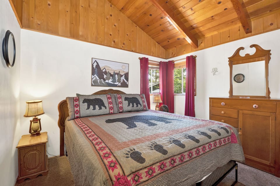 Peaceful cabin bedroom with plush bedding, and beautiful views—ideal for restful nights, cozy mornings, and a relaxing mountain escape.