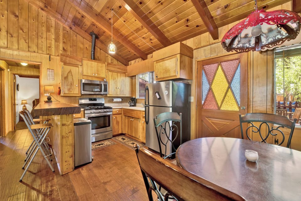 Fully equipped cabin kitchen with ample cabinetry, stove, fridge, microwave, and coffee maker—perfect for cooking meals, morning coffee, and feeling right at home on your stay.