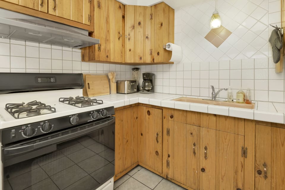 Fully equipped cabin kitchen with ample cabinetry, stove, fridge, microwave, and coffee maker—perfect for cooking meals, morning coffee, and feeling right at home on your stay.