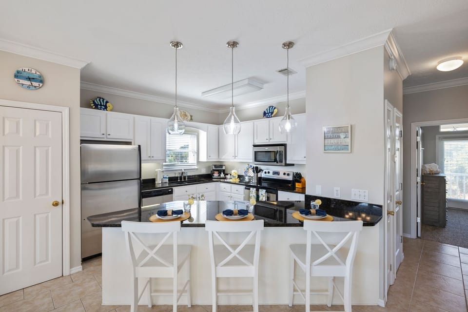 Kitchen offers a bar area with seating for 3 additional people.