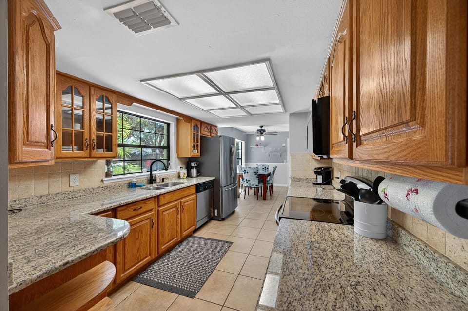 Full kitchen with long counters, ample cabinets, and open layout.