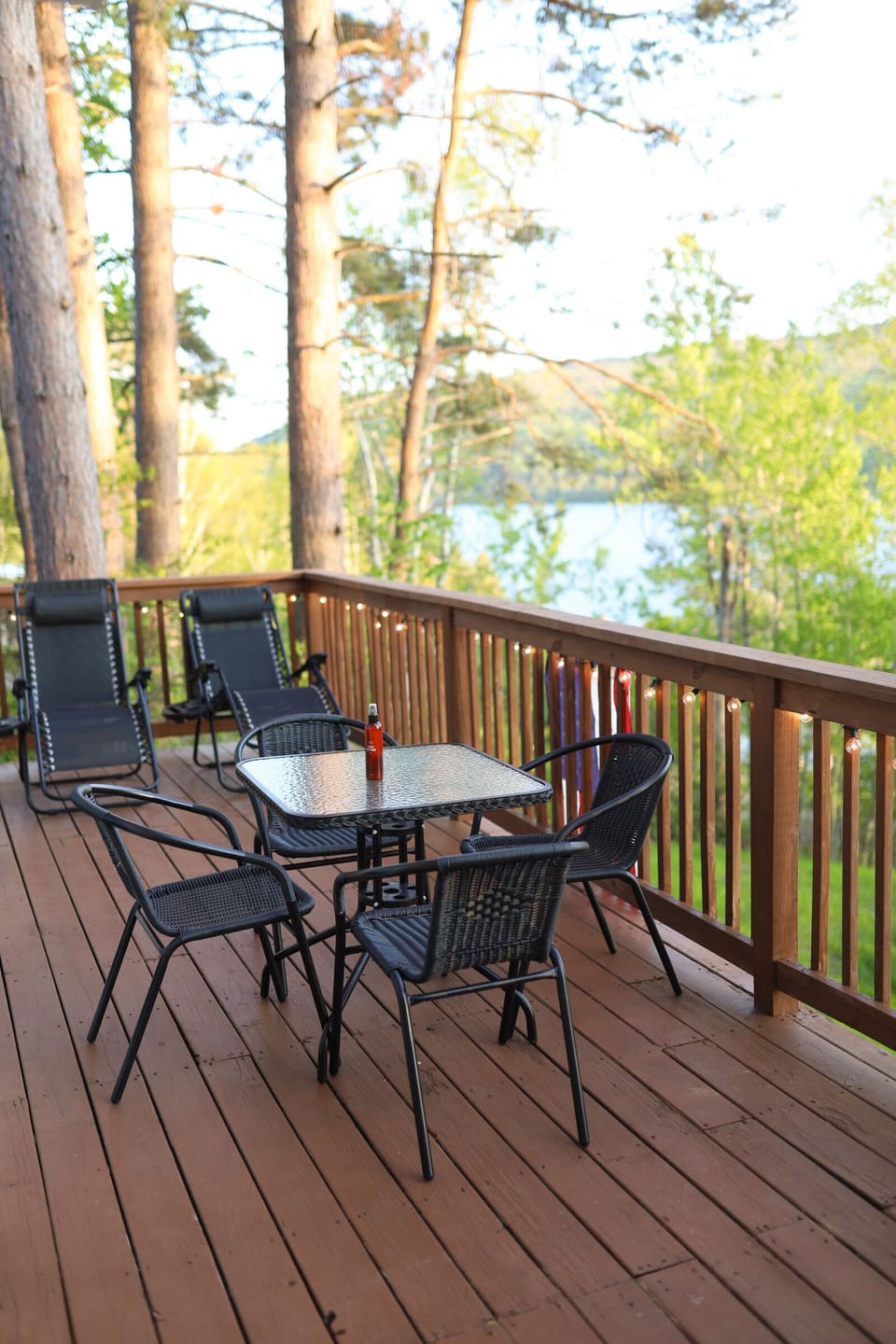 The main deck with an outdoor dining area and zero gravity lounge chairs. 