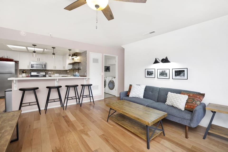 Cozy mountain living room with a fireplace, comfy seating, and smart TV—perfect for relaxing evenings, movie nights, and warm cabin vibes after outdoor adventures.