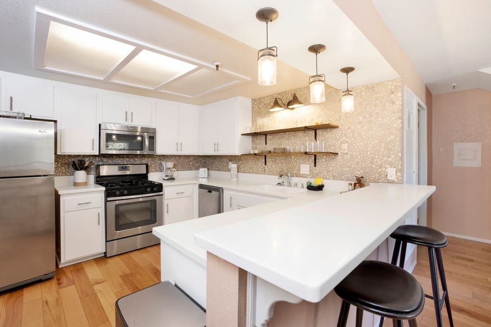 Fully equipped cabin kitchen with ample cabinetry, stove, fridge, microwave, and coffee maker—perfect for cooking meals, morning coffee, and feeling right at home on your stay.