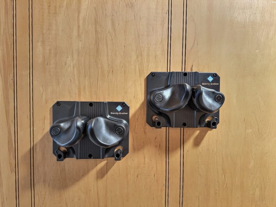 Gravity grabber ski/snowboard holders