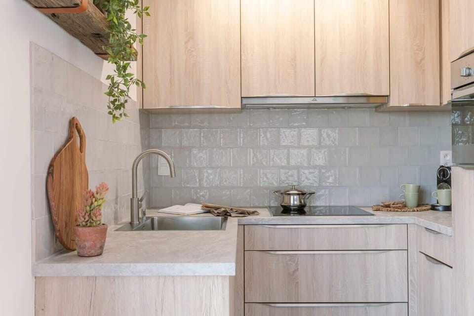 Compact kitchen with natural wood finishes and a clean, modern design.

