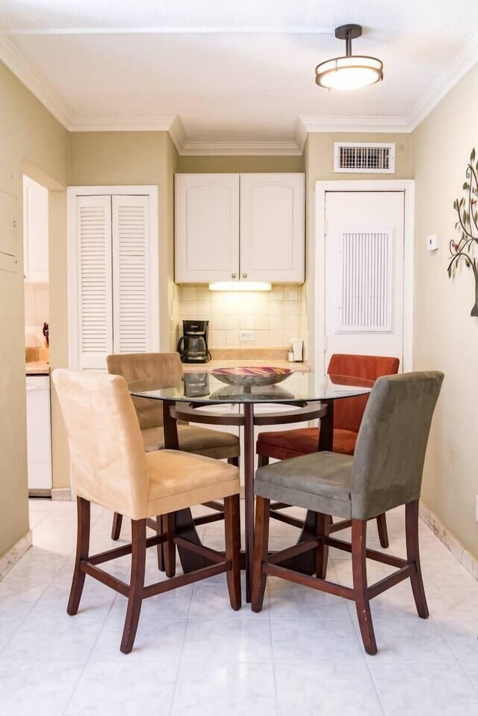 Dining table and entrance to fully stocked kitchen.  Drip coffee maker rests on the bar behind the dining table.  The apartment includes it's own water heater and central air conditioning.