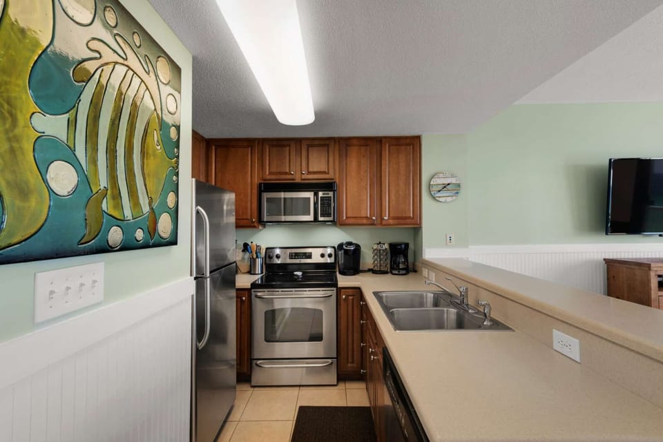 Modern kitchen with stainless steel appliances and wooden cabinetry