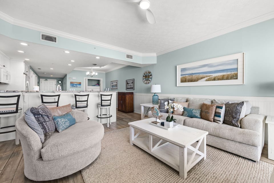Step into your coastal retreat with calming blue walls, plush seating, and beach-themed touches that invite you to unwind in style.