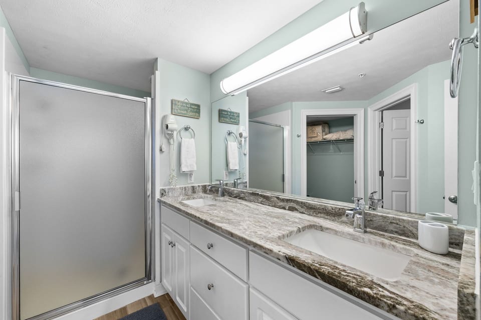 Modern bathroom with a granite countertop and walk-in shower
