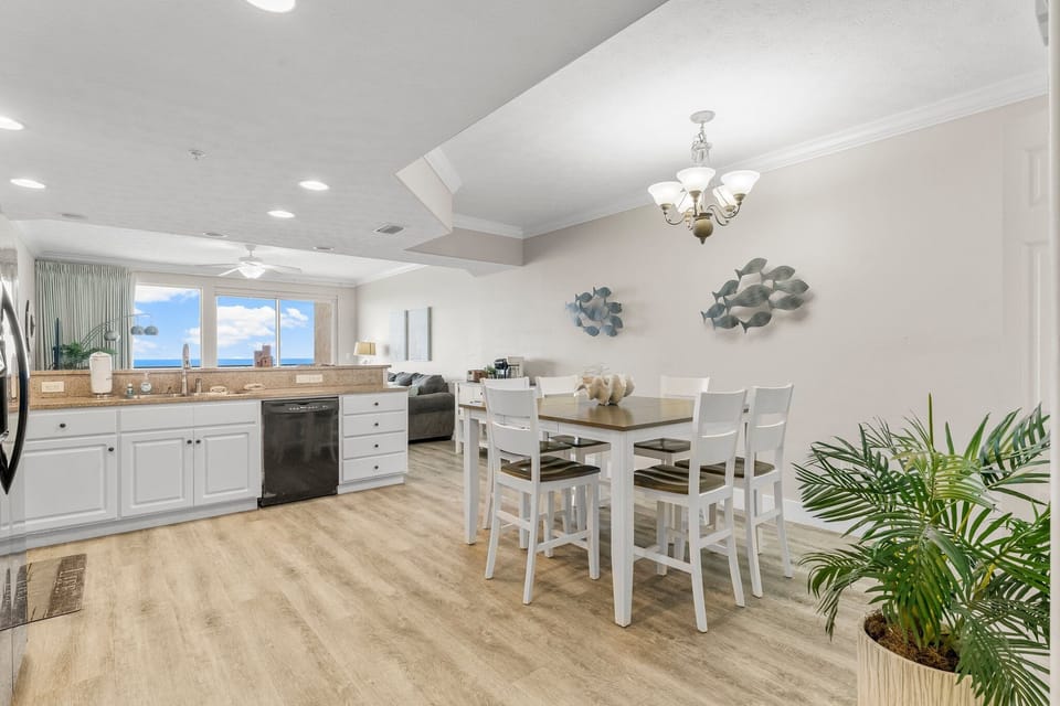 Open-concept kitchen and dining area with natural light and coastal views.