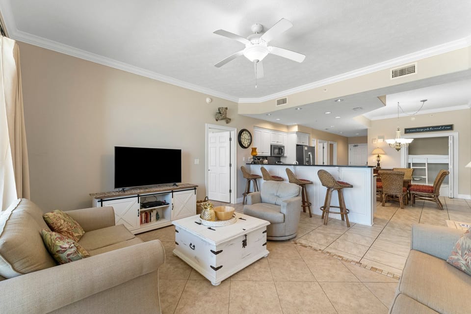 Open living area with a modern kitchen and bar seating for casual dining