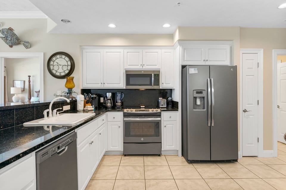 Modern kitchen with stainless steel appliances and white cabinetry
