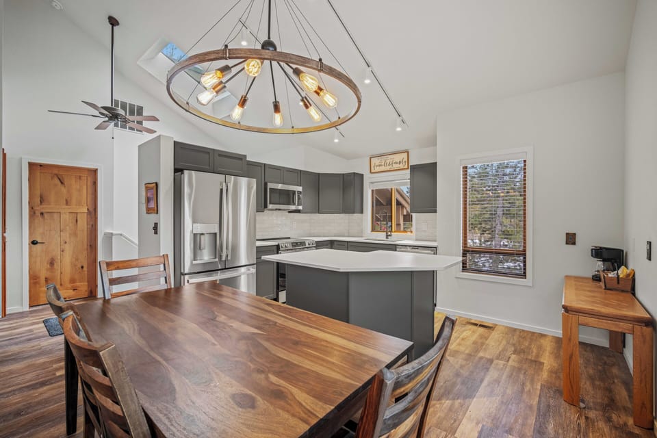 Your open-concept kitchen flows seamlessly into your dining space, complete with modern appliances and stunning chandelier.