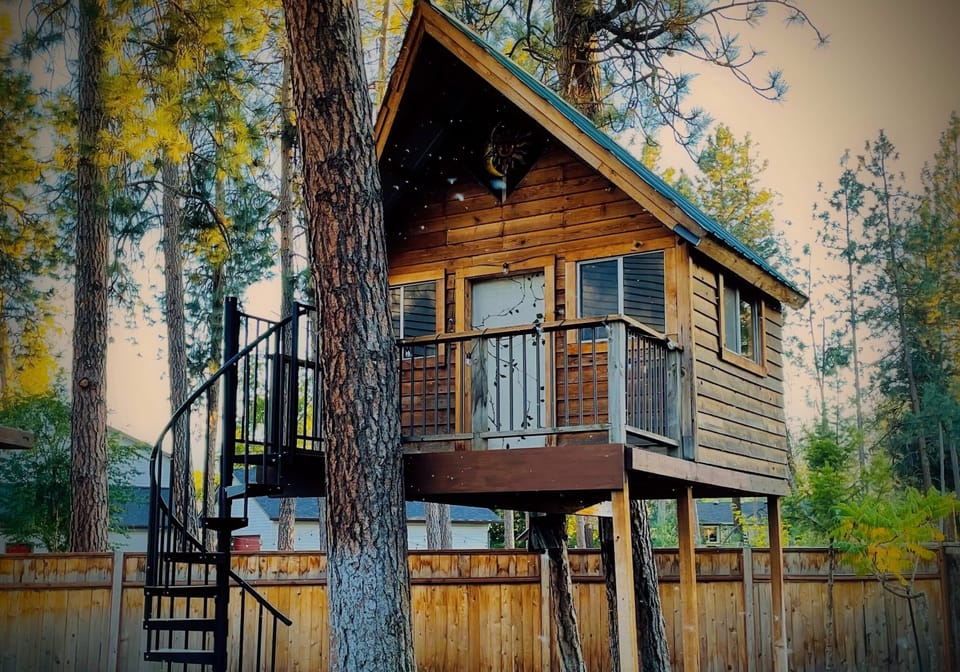 Cozy backyard treehouse is captivating for the young at heart.