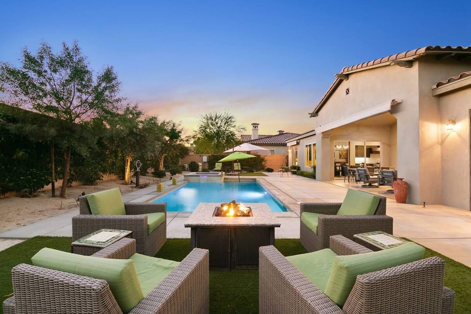 Cozy fire pit lounge beside sparkling pool retreat