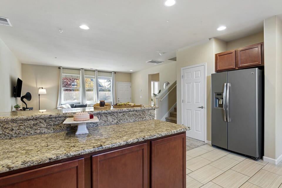 This modern kitchen and living area have ample counter space and cozy seating, ideal for entertaining or relaxing.