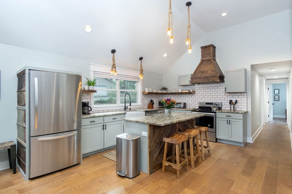 Kitchen complete with island with seating for 3, a dishwasher & a standard Drip coffeemaker.
