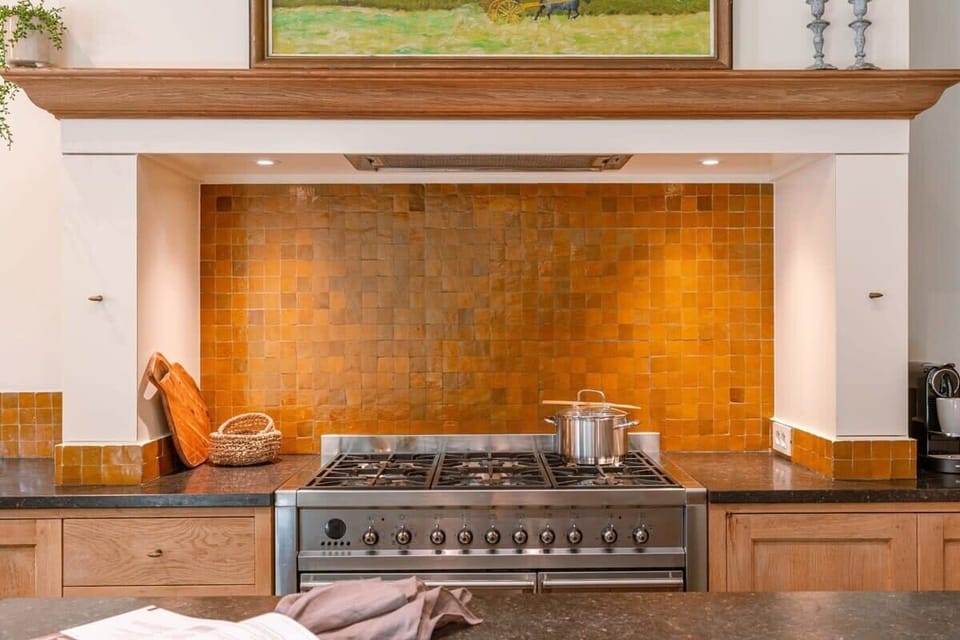 Traditional oven range framed by rustic tiles
