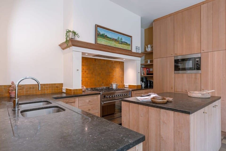 Warm wooden cabinetry and a spacious cooking area
