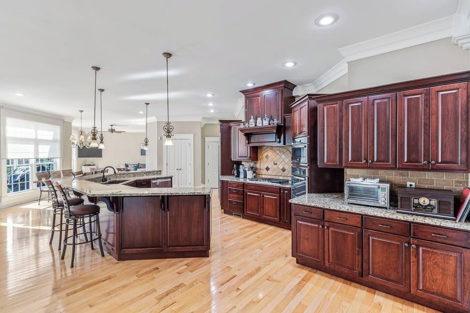 Large kitchen with bar seating, propane stove, multiple coffee makers