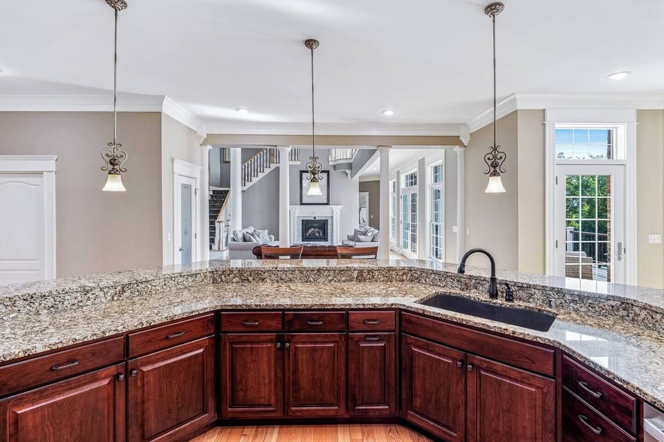 Bar in kitchen looking to two-story living room