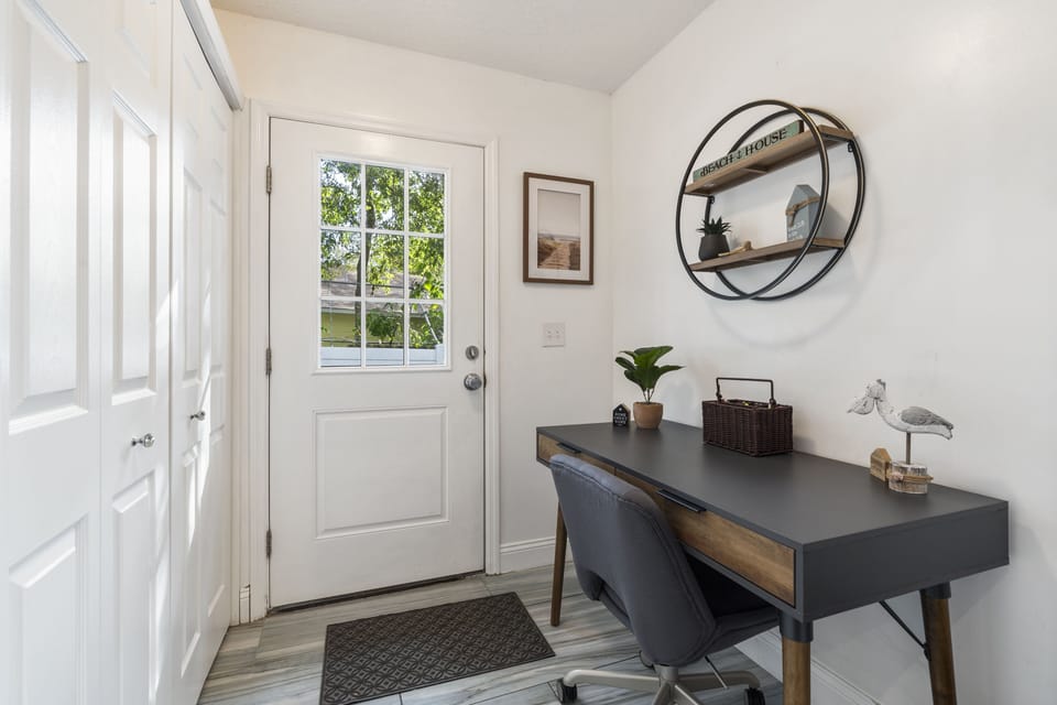 The office space with a comfortable chair, a desk and basic office supplies.