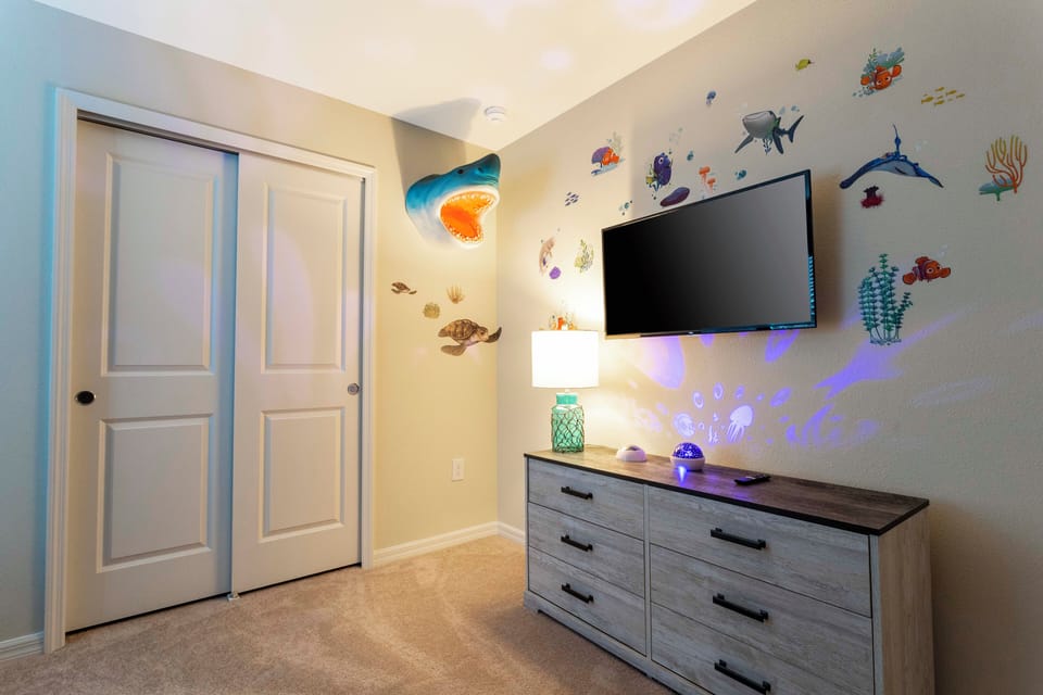 Under sea themed bedroom showing TV and wall art.