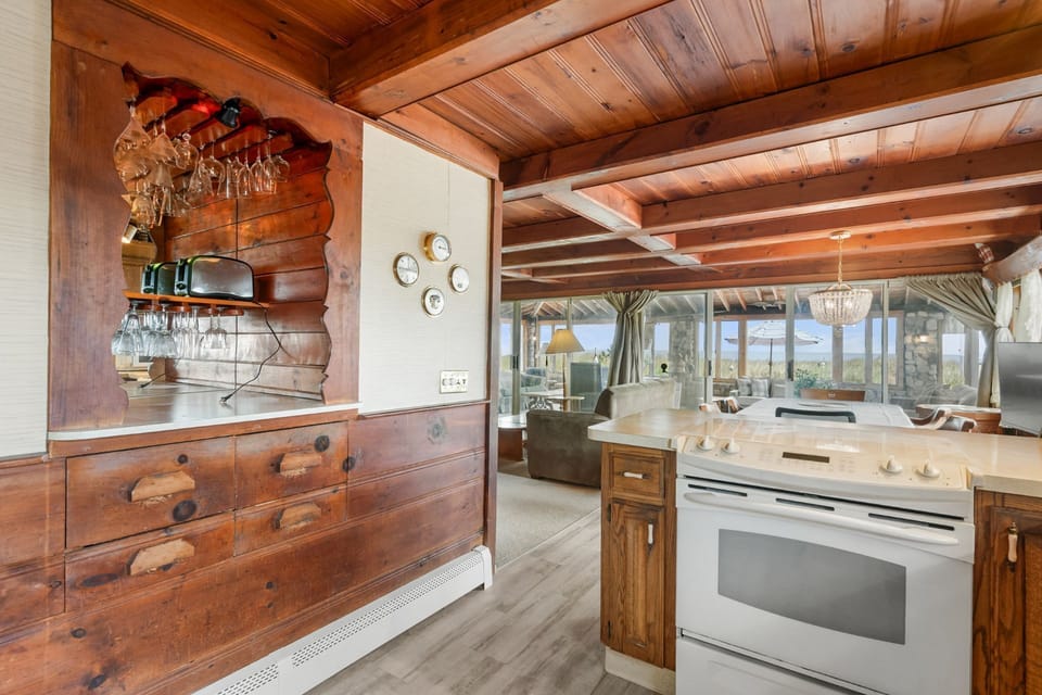 Well-equipped kitchen looking into the living room and dining area