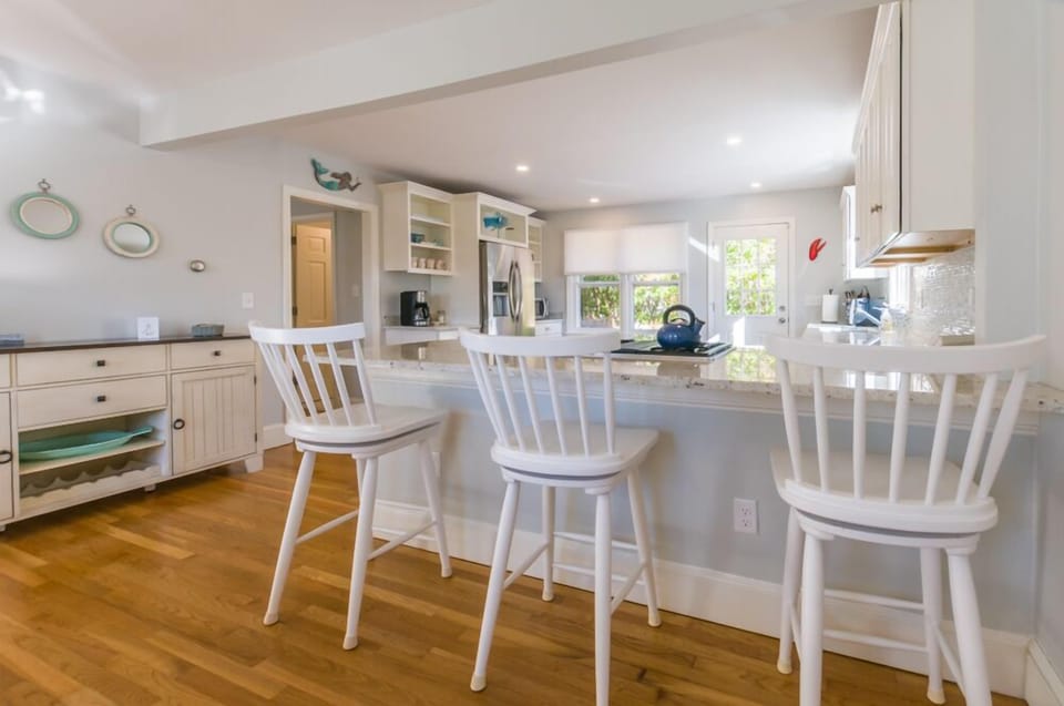 Kitchen with seating for three guests.