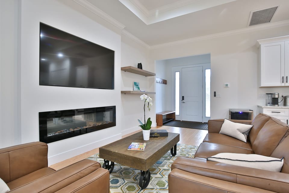 electric fire place below large tv and comfortable seating area