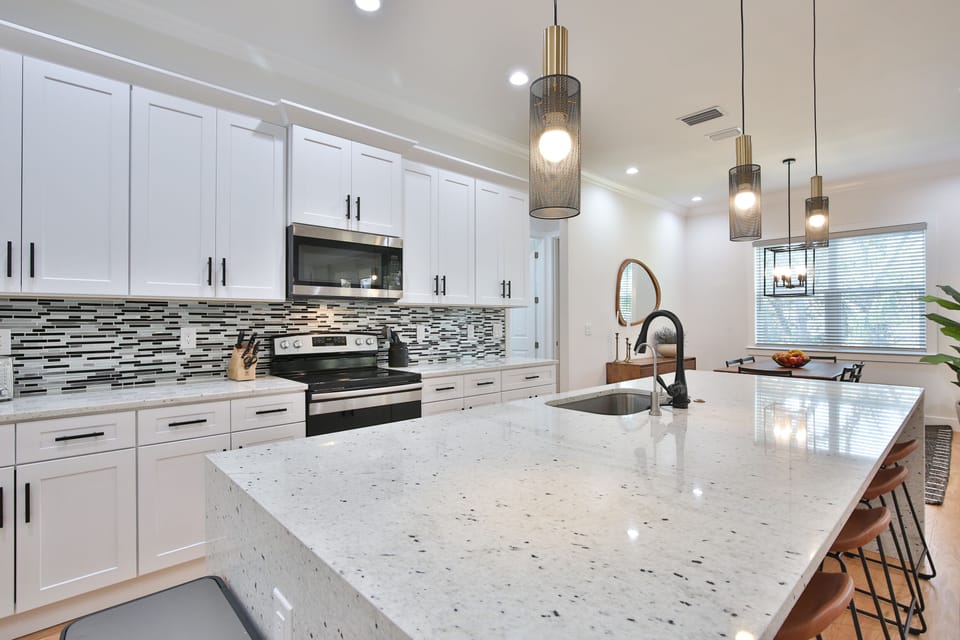 open concept kitchen counter with bar to seat 5 and fully stocked kitchen