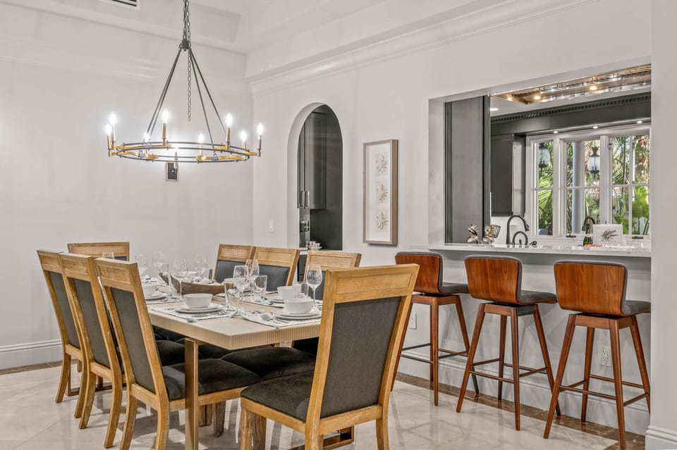 The dining room and kitchen flow together, the bar stool area which seats three and the dining room table seats ten.