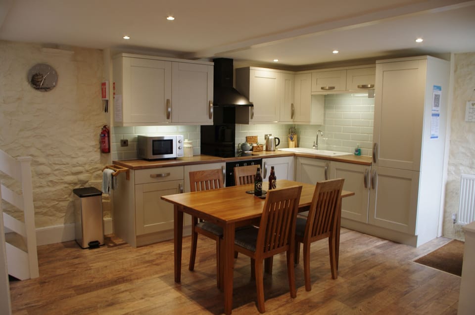 Kitchen with dining area at Forge Cottage in Masham