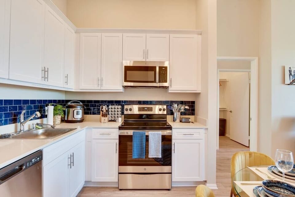 [Kitchen] - cooking utensils, Amazon Alexa, and the following items not shown in picture: blender, pots and pans, cleaning supplies, glasses, mugs, oils, sugar, cooking spray, Tupperware, plastic bags, foil, and more