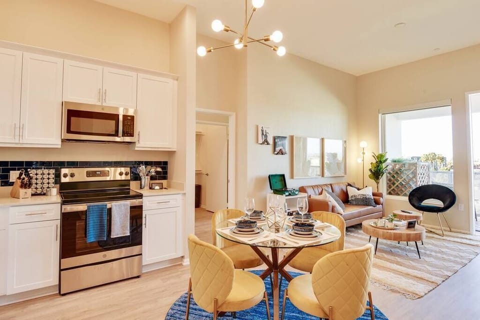 [Kitchen] - stainless steel appliances, four person dining table