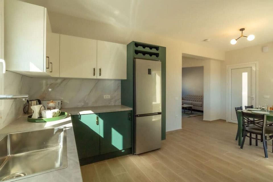 Kitchen is open to the dining room with wine rack over the fridge