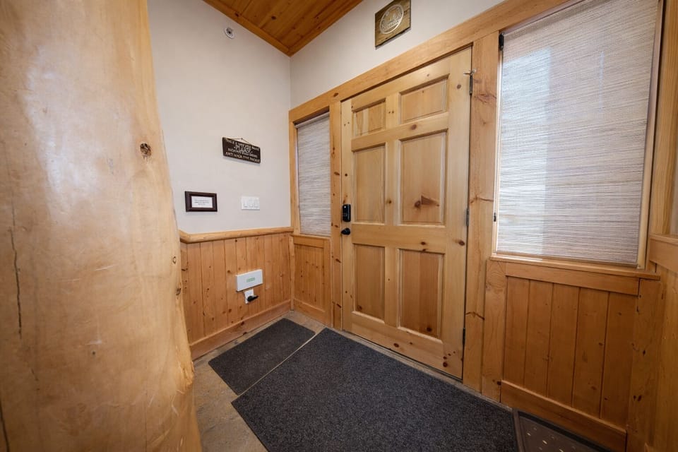 Step into your mountain retreat through this charming rustic entryway, where warm wood details welcome you home after adventurous days.