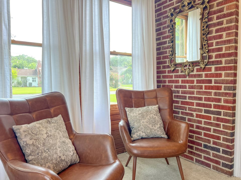 Grab a good book and unwind in this office nook. Enjoy views of the outside from these gorgeous windows.