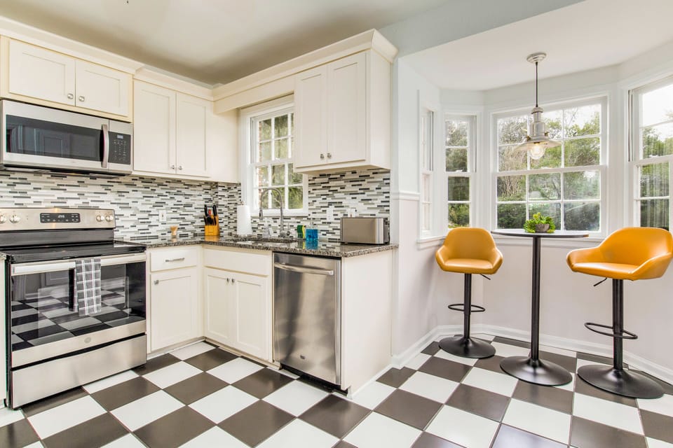 Kitchen comes with a breakfast nook to enjoy coffee while looking outside through the windows.