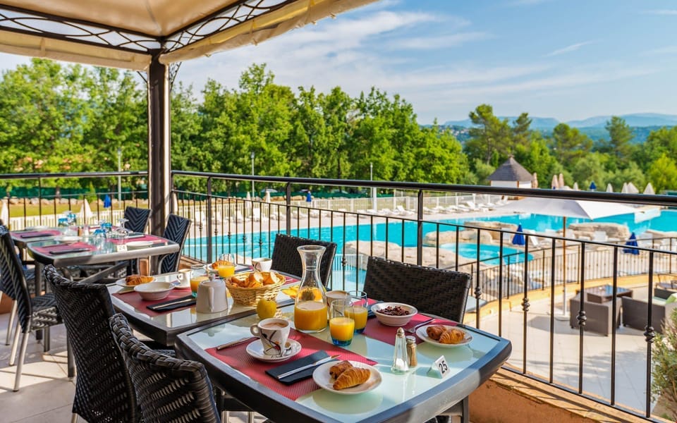 Enjoy dining outdoors on the patio overlooking the pool.