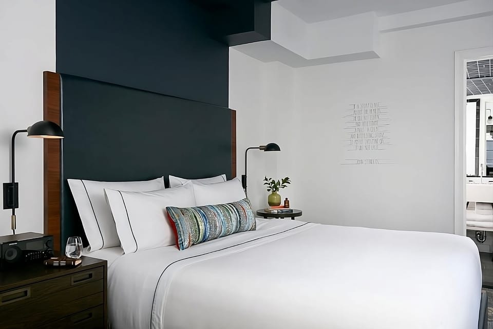 Drift off under soft lighting and a luxe padded headboard.