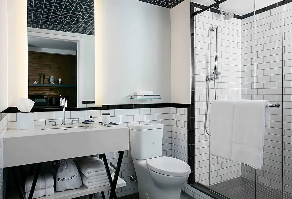 Refresh in a spotless bath with bright mirror lighting.