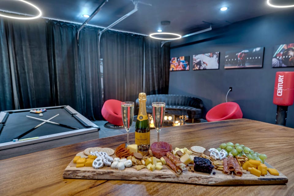 Game room with pool table, bar area, large flat screen TV.