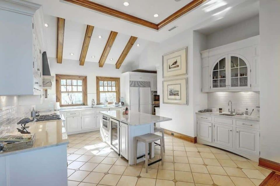 Bright and airy kitchen with ample natural light, offering a welcoming space for meal preparation.