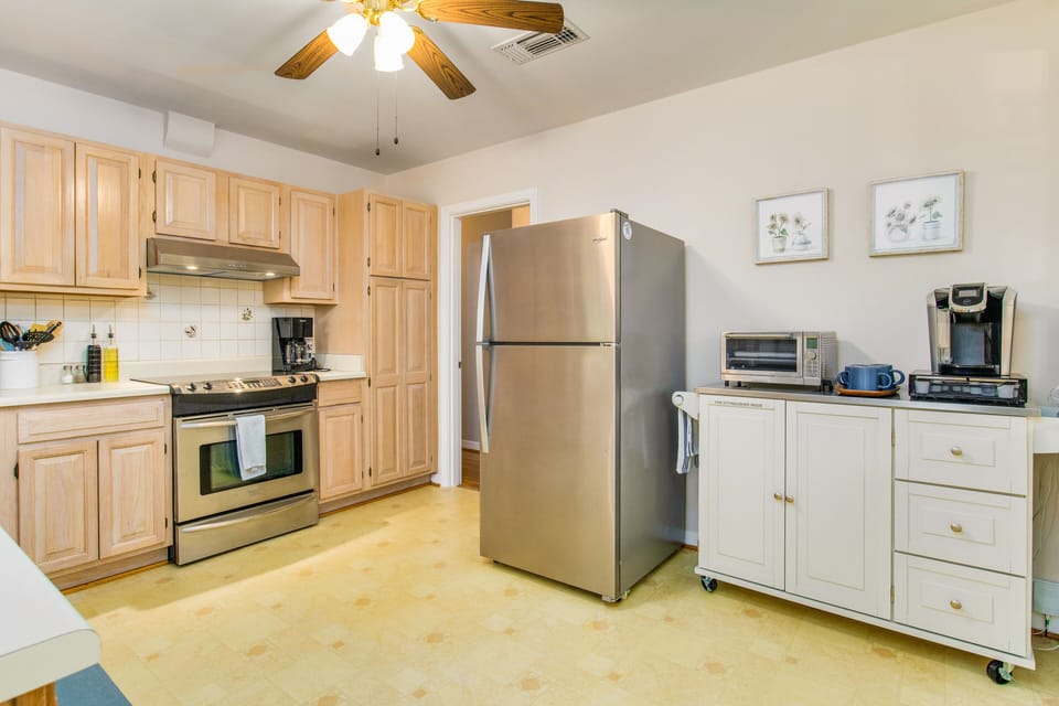 The gleaming stainless steel appliances, including a convenient microwave, oven, dishwasher, and refrigerator, make mealtime a breeze.