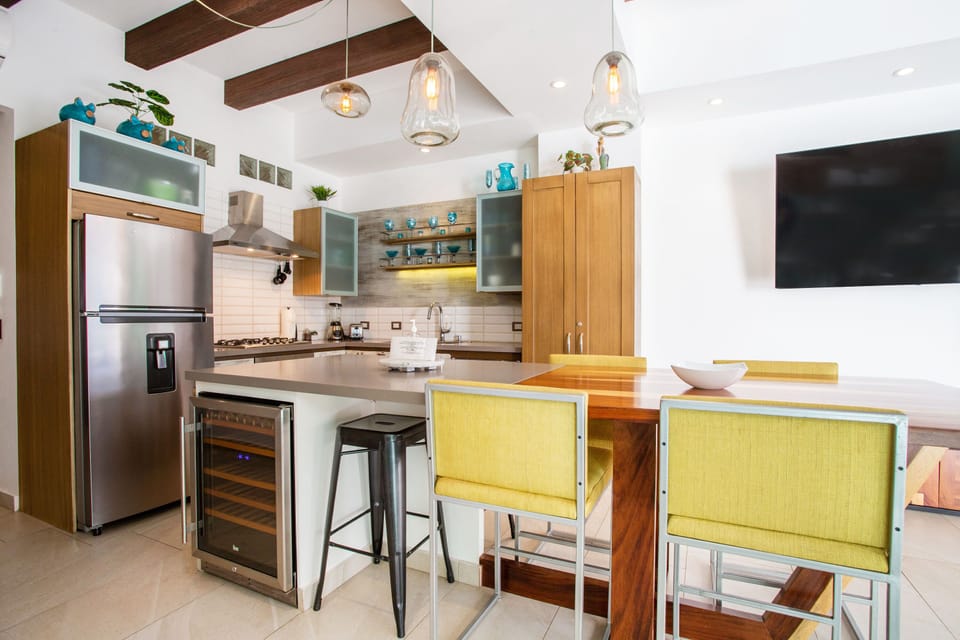One of the kitchen's amenities is a wine-fridge