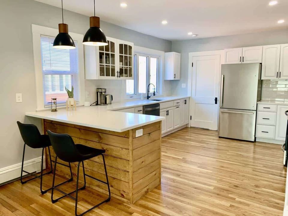 Kitchen: Corner view of the peninsula. Ample working area with a coffee maker (ground coffee)  and multiple cabinets with silverware, dining ware, utensils, etc, etc. 