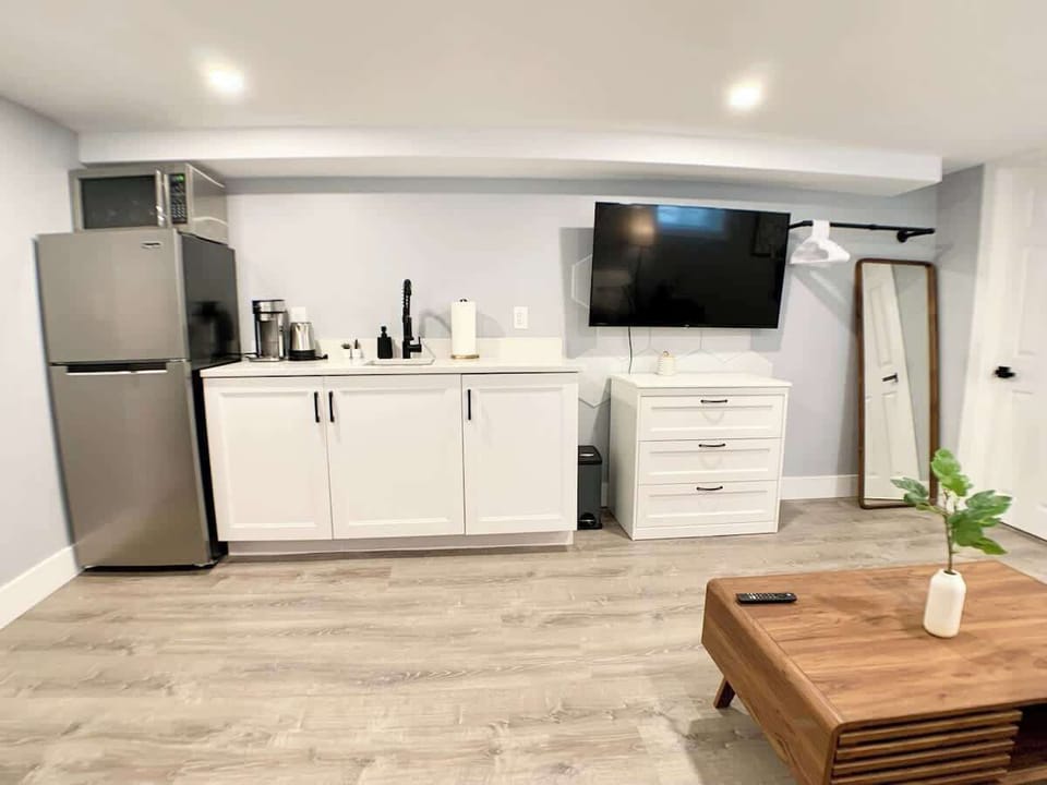 Front view of the kitchenette. 
We have a portable induction hotplate, stored inside the cabinets.
The coffee maker works with ground coffee. 
We provide utensils, silverware, dining ware, etc. 